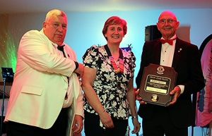Bob Prevost (R) receives his Melvin Jones Fellowship from District Governor David (L) and Lion President Jane (C)